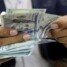 تحذيرات من تداعيات اقتصادية لقرار تحرير الدولار الجمركي وزيادة الرواتب